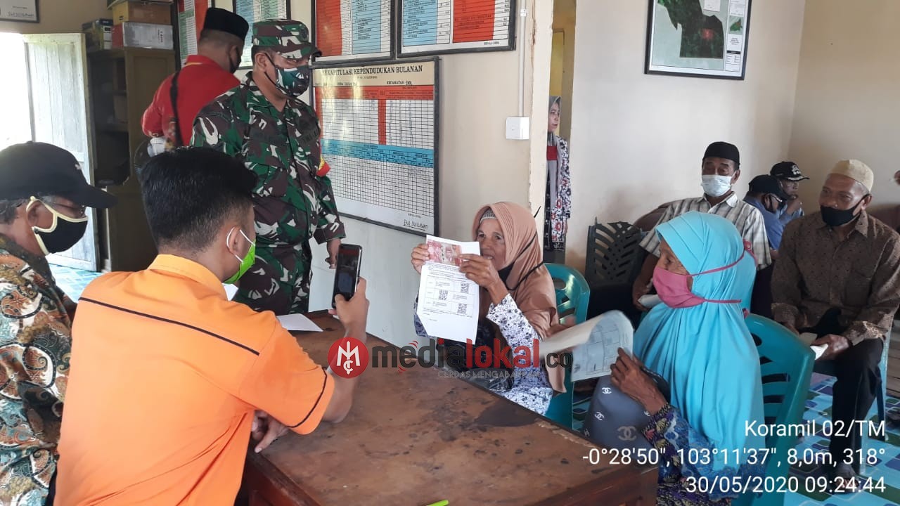 Babinsa Koramil 02/Tanah Merah Kawal Penyaluran BST di Kecamatan Enok