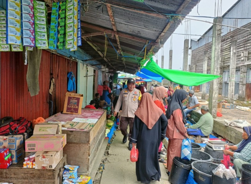 Bhabinkamtibmas Desa Belantaraya Patroli Jalan Kaki di Pasar Mingguan untuk Wujudkan Harkamtibmas yang Kondusif
