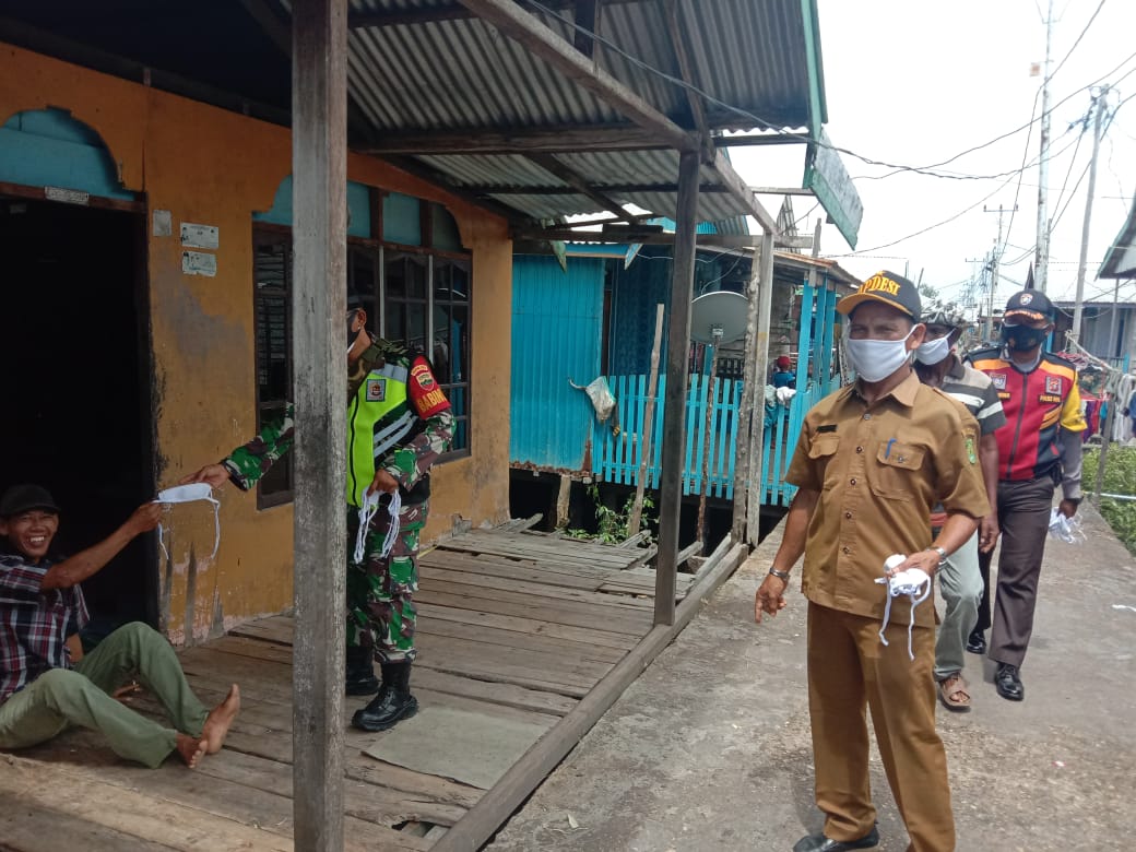 Babinsa Koramil 04/Kuindra dan Kades Sungai Bela Bagikan Masker Geratis